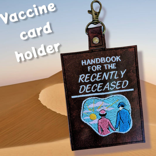 Handbook for the Recently Deceased vaccine card protector. Attach to purse, bag, backpack or beltloops Vinyl, vegan leather.