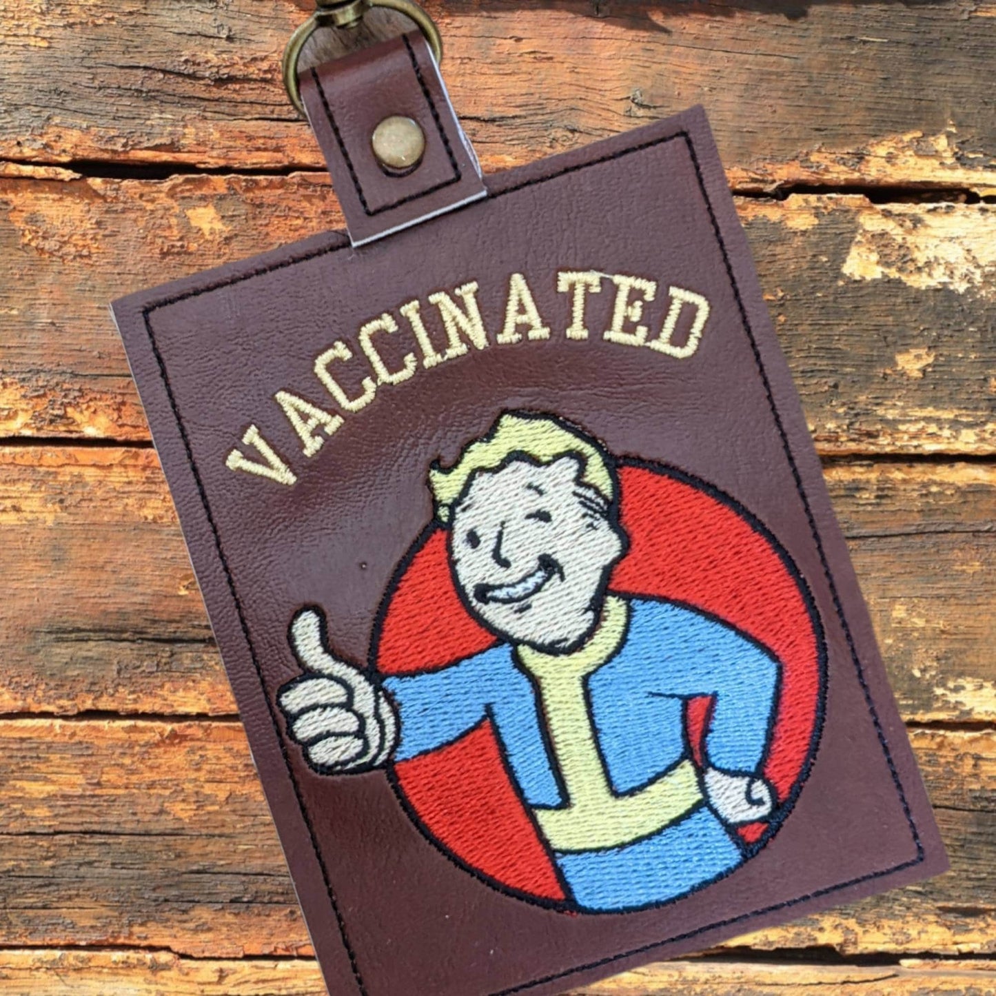 Wasteland kid vaccination card protector. Attach to purse, bag, backback or beltloops Vinyl, cork, leather.