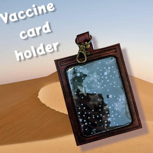 Handbook for the Recently Deceased vaccine card  protector. Attach to purse, bag, backpack or beltloops Vinyl, vegan leather.