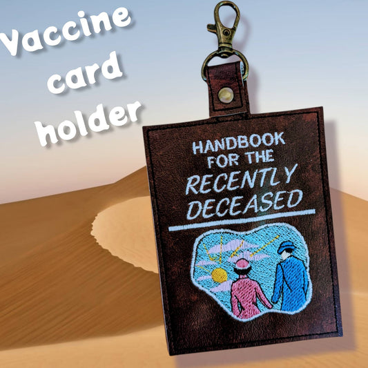 Handbook for the Recently Deceased vaccine card  protector. Attach to purse, bag, backpack or beltloops Vinyl, vegan leather.