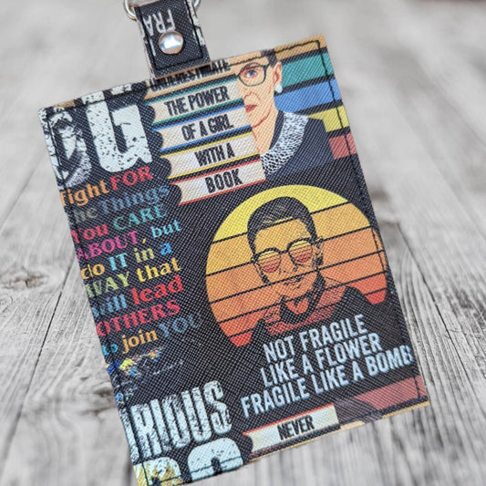 The Notorious RBG vaccine card  protector. Attach to purse, bag, backpack or beltloops Vinyl, vegan leather.